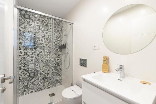 a bathroom with a shower and a sink and a mirror at Apartamento Terraza al Mar, Nerja in Nerja