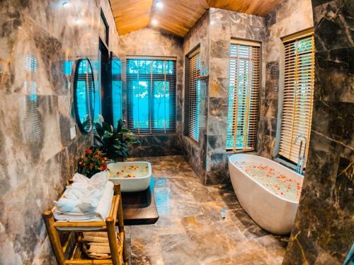 ein Badezimmer mit 2 Waschbecken und einer Badewanne in der Unterkunft Pu Luong Eco Garden in Pu Luong