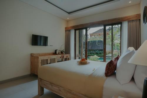 Postel nebo postele na pokoji v ubytování LASTANA SUITE UBUD