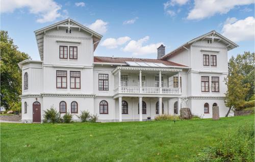 a large white house with a large yard at Nice Apartment In Tranås in Tranås