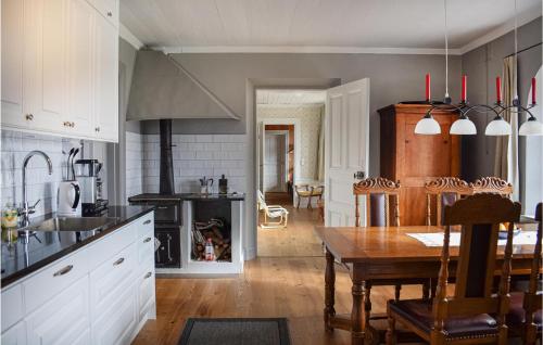a kitchen with a table and a dining room at Nice Apartment In Tranås in Tranås