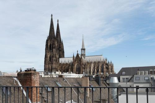 a cathedral with turrets and spires in a city at Legend Hotel in Cologne