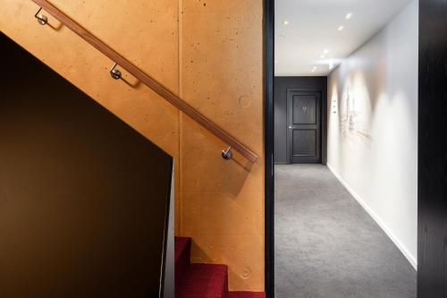 a hallway with stairs leading to a door at Legend Hotel in Cologne