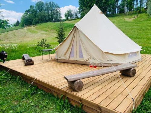 a white tent sitting on a wooden deck at Murimäe Winery glamping in Otepää