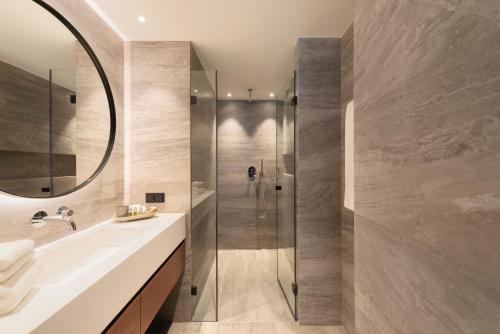 a bathroom with a shower and a sink at Legend Hotel in Cologne