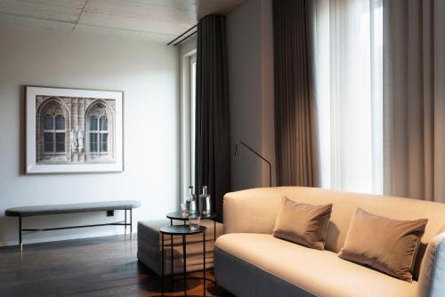 a living room with a couch and a table at Legend Hotel in Cologne