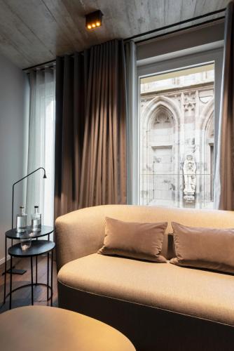 a bedroom with a bed and a window and a table at Legend Hotel in Cologne