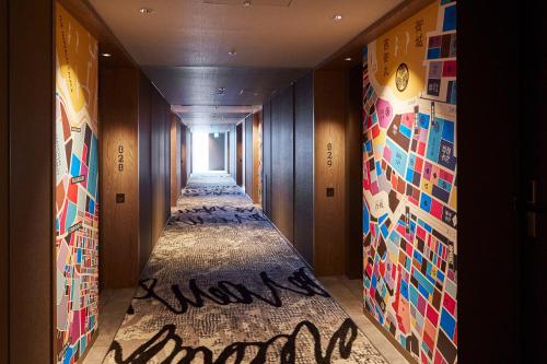 a hallway with many different types of art on the walls at Tokyo Bay Shiomi Prince Hotel in Tokyo