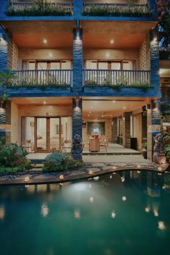 a house with a swimming pool in front of it at LASTANA SUITE UBUD in Ubud