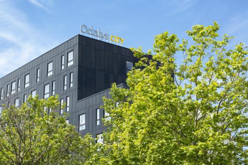 an office building with a sign on top of it at Appart Hotel Odalys City Le Havre Centre in Le Havre