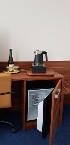 a microwave oven sitting on top of a wooden table at Wellness & SPA Lipno - Frymburk C410 in Frymburk
