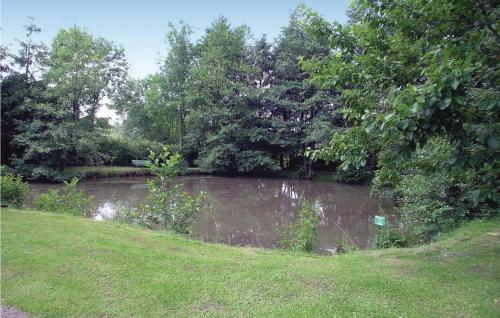 a pond in the middle of a park with trees at 2 Bedroom Lovely Home In Dimont in Dimont