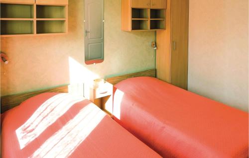 a bedroom with a red bed and cabinets at 2 Bedroom Lovely Home In Dimont in Dimont
