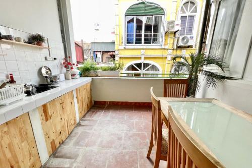 a kitchen with a sink and a window and a table at Vitamin Home Hoàn Kiếm 35 in Hanoi