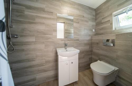 a bathroom with a white sink and a toilet at Pensjonat Basia in Dziwnówek