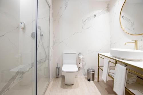 a bathroom with a toilet and a sink and a shower at Grupotel Gravina in Barcelona