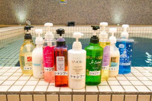 a group of bottles of detergent sitting on a bathroom counter at Kur and Hotel Shinshu in Shiojiri
