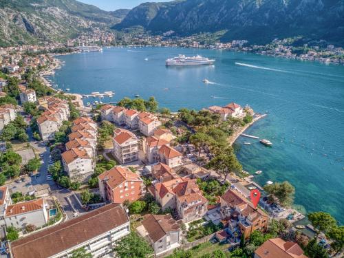 an aerial view of a town with a cruise ship in the water at Stone Home Kotor in Dobrota