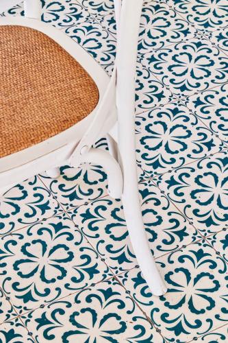 a bathroom floor with a blue and white pattern at Hotel Astoria in Garda