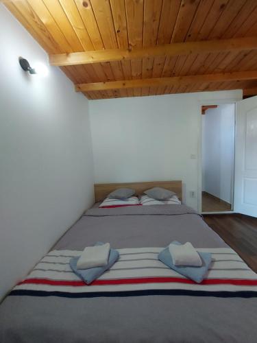 a bedroom with a large bed with two pillows at C Dor de Vama Bedrooms in Vama Veche