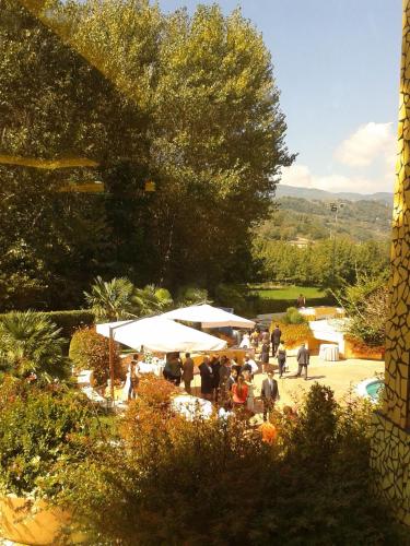 a group of people standing in a garden with umbrellas at L'Isola Di Aurora in Martirano