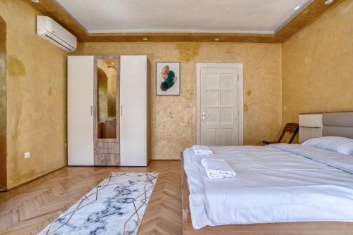 a bedroom with two beds and a door in it at Stone Home Kotor in Dobrota