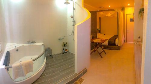a bathroom with a bath tub and a bedroom at MONKEY'S HOTEL in Okinawa City