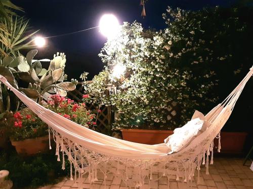 a hammock in a garden at night at Mirella Charming in Alberobello
