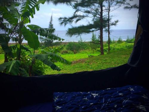 a view of the ocean from a bedroom window at Jimmy Explorer Campsite and Dive Center in Lanyu