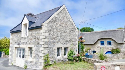 a stone house with a black roof at Ker-Yann in Plouharnel