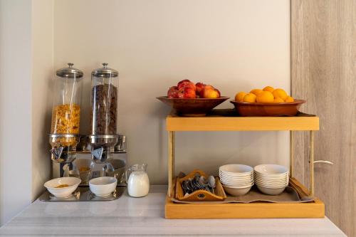 a shelf with bowls of fruit and plates on it at Troulis Seaside in Amoudara Herakliou