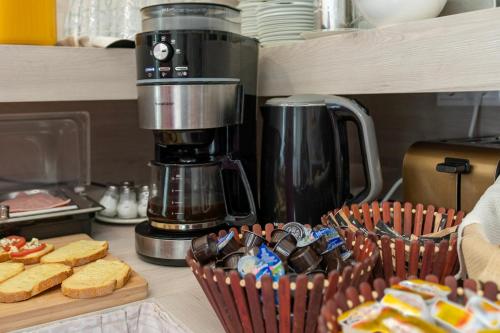 a counter with a coffee maker and a basket of food at Troulis Seaside in Amoudara Herakliou