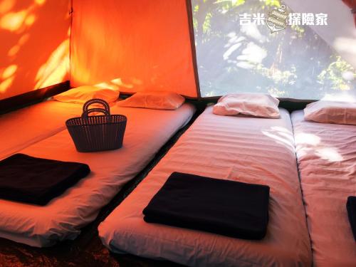 a room with two beds in a tent at Jimmy Explorer Campsite and Dive Center in Lanyu