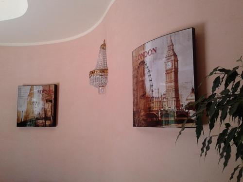 a wall with two pictures of big ben and big clocks at L'Isola Di Aurora in Martirano