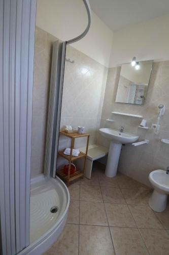 a bathroom with a shower and a sink and a toilet at Agriturismo Monte Istulargiu in Valledoria