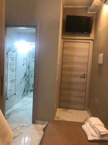a bathroom with a shower and a sliding glass door at Le Suite di Via Veneto,35 in Crotone