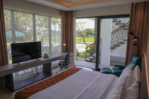 A bed or beds in a room at The Valerian Villa Ubud