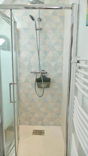 a shower with a glass door in a bathroom at Ker-Yann in Plouharnel