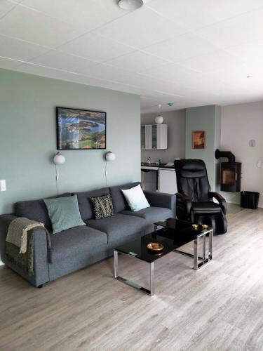a living room with a couch and a chair at Naturperlen in Rødekro