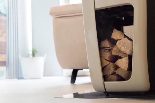 a television with a pile of fire wood in it at Luz de Viro in Outes