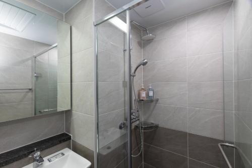 a bathroom with a shower and a sink at Golden Planet Hotel in Icheon
