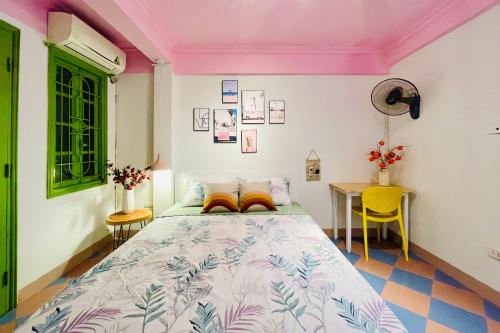 a bedroom with a bed with a pink ceiling at Vitamin Home Hoàn Kiếm 35 in Hanoi