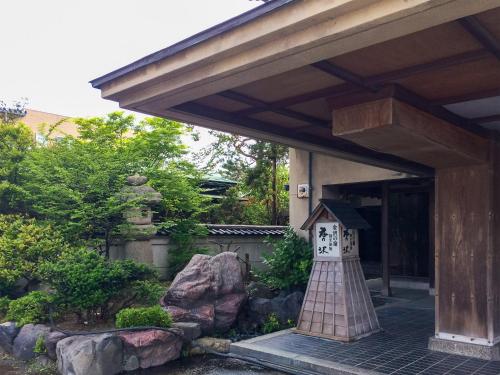 a house with a clock on the front of it at Ryokan Karasawa in Kanazawa