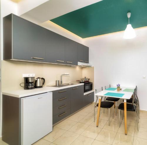 a kitchen with a table and a counter top at Blue Boutique Apts in Amoudara Herakliou