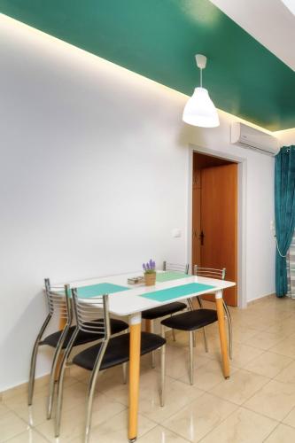 a dining room with a table and chairs at Blue Boutique Apts in Amoudara Herakliou