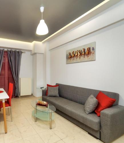 a living room with a couch and a table at Blue Boutique Apts in Amoudara Herakliou
