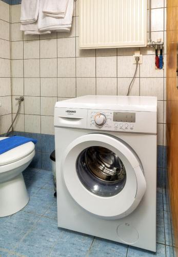 a washing machine in a bathroom with a toilet at Blue Boutique Apts in Amoudara Herakliou