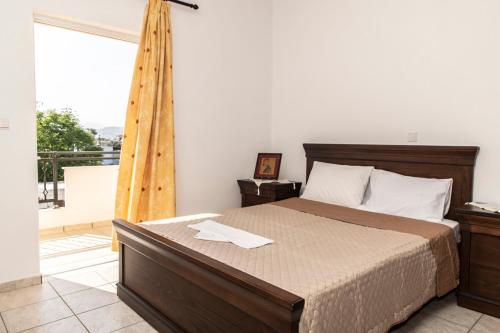 a bedroom with a bed and a balcony at Timbaki'Theodosia'T Brothers in Tympáki