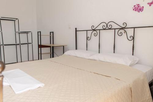 a bedroom with two beds with white sheets at Timbaki'Theodosia'T Brothers in Tympáki