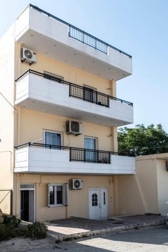 a tall building with balconies on the side of it at Timbaki'Theodosia'T Brothers in Tympáki